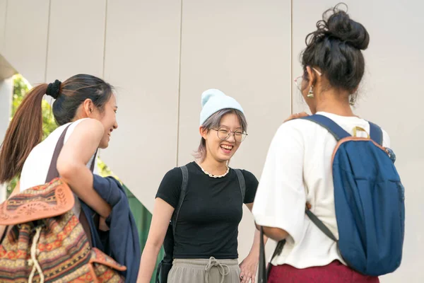 Group of young college multi-racial women students standing and laughing together.