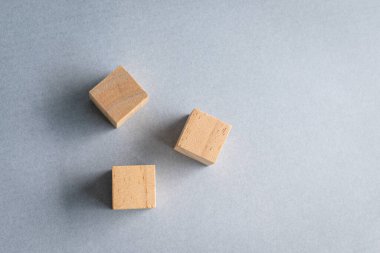 Three blank wooden cubes on top of table, top view. Free text and copy space.