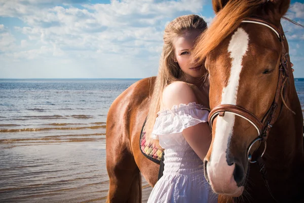 Beautiful blonde woman and a horse — Stock Photo, Image