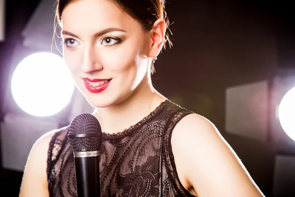 Close-up portrait of beautiful elegant woman with microphone — Stock Photo, Image