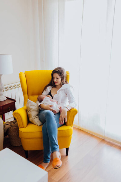 Young Mom Breastfeeding Her Newborn Baby Boy Sitting Yellow Armchair Stock Picture