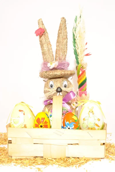 Easter eggs in a basket and bunny — Stock Photo, Image