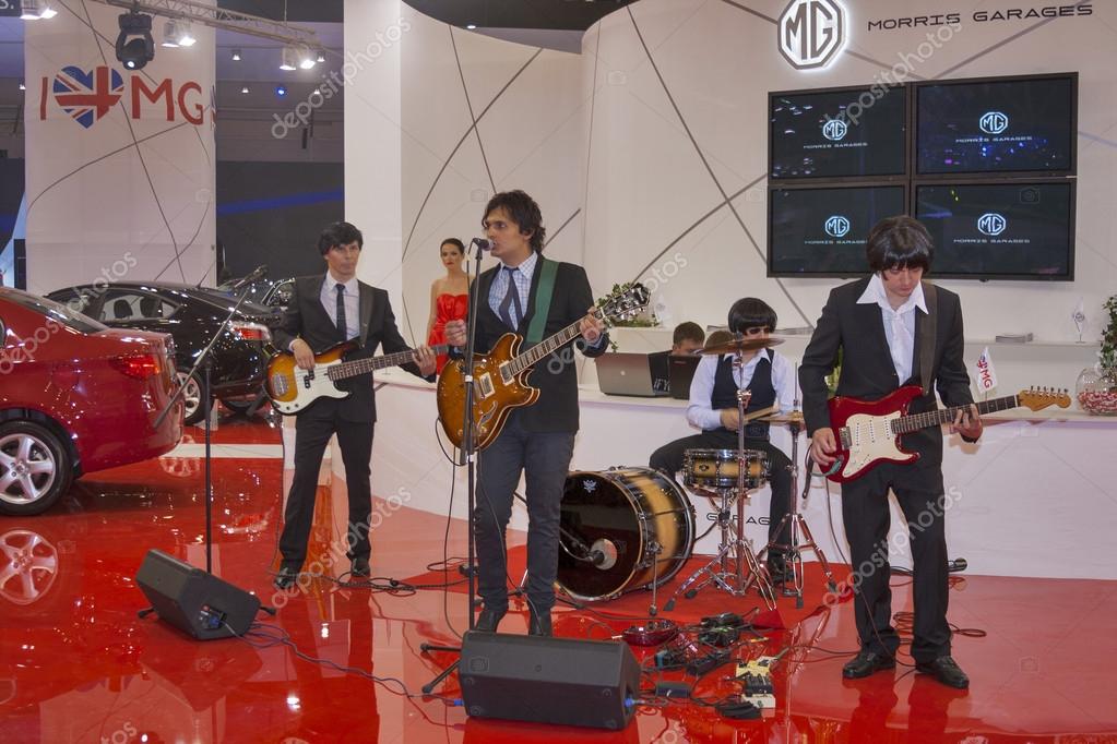 KIEV, UKRAINE - MAY 29: Unknown rock band simulates The Beatles at Morris Garages presentation on display of SIA' 2013 The 21st Kyiv International Motor Show in International Exhibition Centre on May 29, 2013 in Kiev, Ukraine.