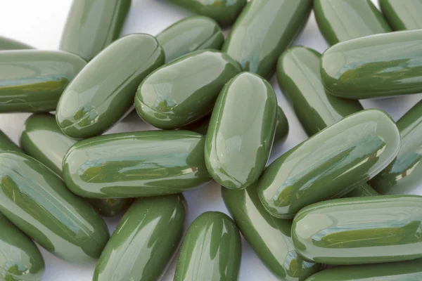 Green gelatinous capsules background — Stock Photo, Image