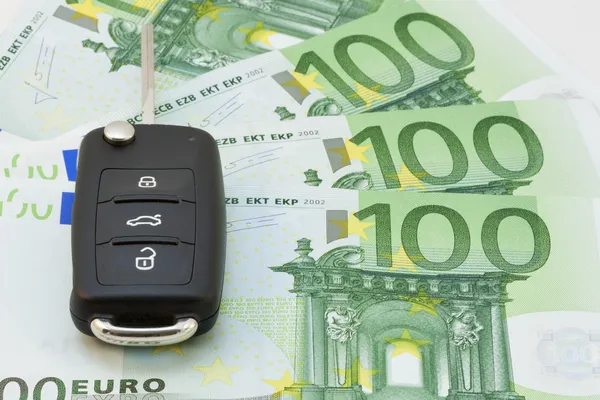 Ключи от машины через банкноты евро — стоковое фото