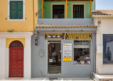 Leflimmi, Korfu, Yunanistan - 05 Ağustos 2021: Küçük bir kasabadaki fotoğrafçı cephesi. Korfu, İyon Denizi 'nde bir Yunan adasıdır. Lefkimmi adadaki en güneydeki belediye birimidir..