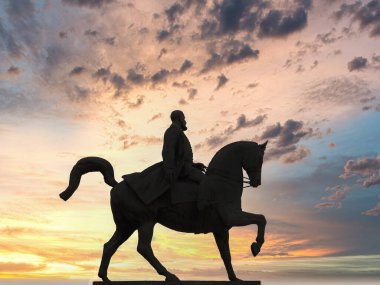 Silhouette of the statue of Carol I the first king of modern Romania against a dramatic sunset in Bucharest