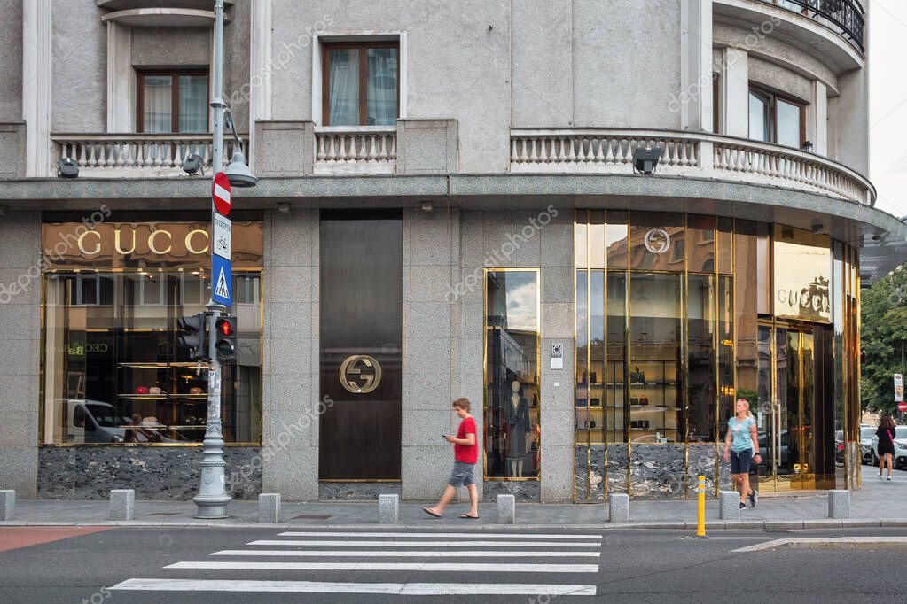 Bucharest, Romania - August 12, 2021: People walk along Gucci store in downtown. Gucci product lines include handbags, ready to wear, footwear, accessories, makeup, fragrances, home decoration.