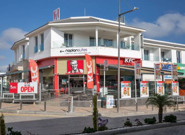 Ayia Napa, Kıbrıs - 28 Mayıs 2021: KFC restoran binası. KFC ya da Kentucky Fried Chicken, kızarmış tavuk üzerine uzmanlaşmış bir fast food restoran zinciri..