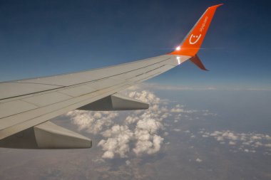 Larnaca, Cyprus - May 31, 2021: SkyUp Airlines Ukrainian charter and low-cost aircraft wing flying at high altitude against clear blue sky. In 2021 the airline performed 15,962 flights.