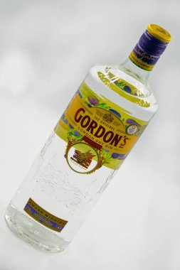 Kyiv, Ukraine - March 27, 2021: The Original Gordons premium London dry gin bottle closeup against white. Gin is a distilled alcoholic drink that derives its predominant flavour from juniper berries. clipart
