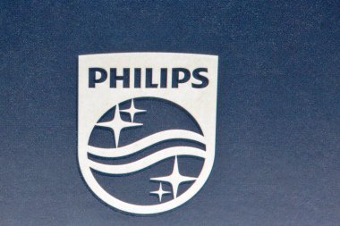Kyiv, Ukraine - April 03, 2021: Studio shot of modern Philips electric shaver logo closeup. Philips is a Dutch multinational conglomerate corporation.