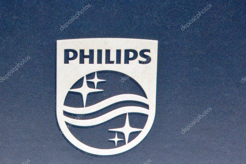 Kyiv, Ukraine - April 03, 2021: Studio shot of modern Philips electric shaver logo closeup. Philips is a Dutch multinational conglomerate corporation.