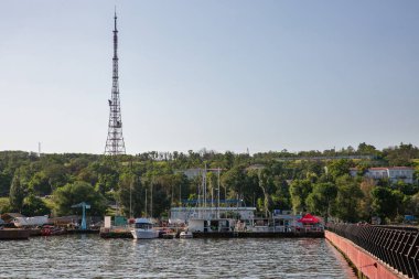 Mariupol, Ukraine - July 15, 2021: Cityscape with Azovstal yacht club and TV tower. During the 2022 Russian invasion of Ukraine the city was besieged and largely destroyed. clipart