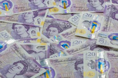 British twenty pounds sterling banknotes closeup background. Portrait if Queen Elizabeth II.