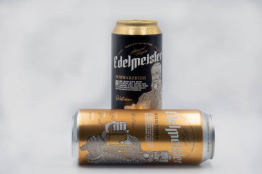 Kyiv, Ukraine - April 24, 2021: Edelmeister weissbier and dark lager beercans closeup against white background. Made in Poland by Van Pur S.A.