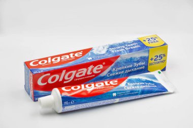 Kyiv, Ukraine - June 18, 2022: Colgate calcium and fluoride toothpaste tube and pack closeup against white. Colgate is a manufacturer of a wide range of toothpastes, toothbrushes, and mouthwashes.