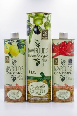 Corfu, Greece - August 05, 2021: Studio shoot of Mavroudis Corfu Family Olive Oil unfiltered tins closeup on white. Gourmet Lemon, Extra Virgin and Gourmet Chilli.