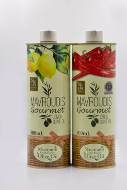 Corfu, Greece - August 05, 2021: Studio shoot of Mavroudis Corfu Family Olive Oil unfiltered tins closeup on white. Gourmet Lemon and Gourmet Chilli.