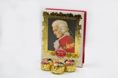 Kyiv, Ukrasine - December 26, 2021: Mozart Kugeln traditional sweets box closeup on white. Largest producer of Mozartkugeln is the German company Reber Specialities.