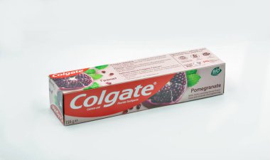 Kyiv, Ukraine - October 31, 2021: Colgate pomegranate calcium and fluoride toothpaste pack closeup on white. Colgate is a manufacturer of a wide range of toothpastes, toothbrushes, and mouthwashes.