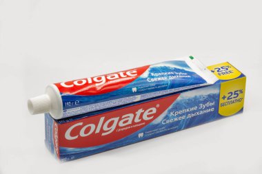 Kyiv, Ukraine - June 18, 2022: Colgate calcium and fluoride toothpaste tube and pack closeup against white. Colgate is a manufacturer of a wide range of toothpastes, toothbrushes, and mouthwashes.
