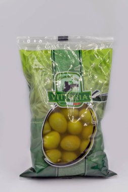 Kyiv, Ukraine - August 23, 2021: Studio shoot of big green pitted whole italian olives Vittoria package closeup on white.