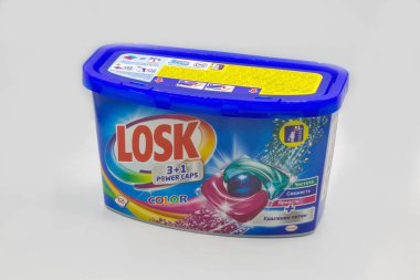 Kyiv, Ukraine - October 31, 2021: Studio shoot of Henkel Losk color washing gel power caps package closeup against white. Henkel is a German multinational chemical and consumer goods company.