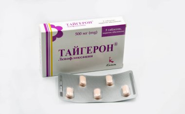 Kyiv, Ukraine - November 21, 2021: Taygeron levofloxacin antibiotic drug tablets blister and box by Kusum closeup on white. It is used to treat bacterial infections including sinusitis, pneumonia.