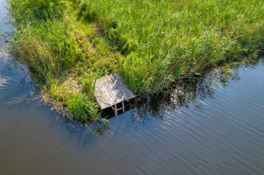 Drone aerial view over wooden pavement for fishing and swimming on summer river Ros, Ukraine.