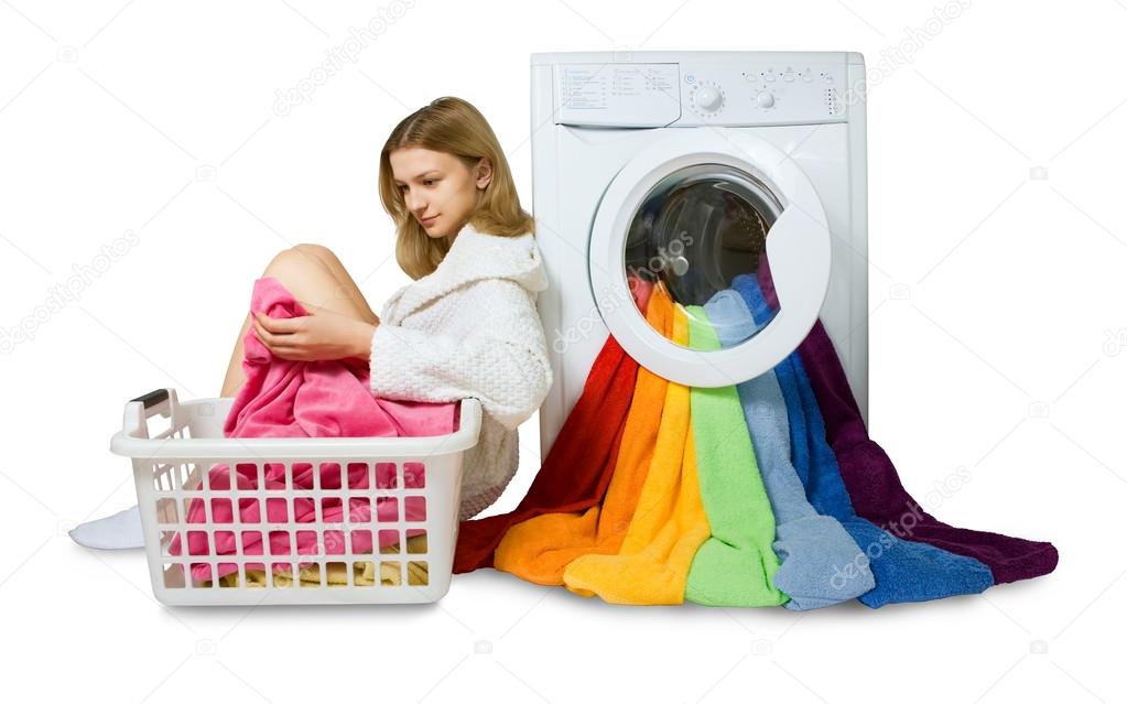 young girl and washing machine with colorful things to wash, iso
