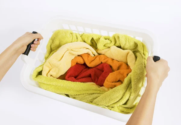 Woman holding a basket with color laundry to wash — Stock Photo, Image