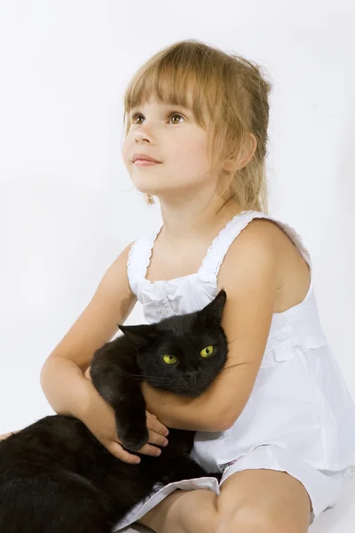 Little girl with a black cat — Stock Photo, Image