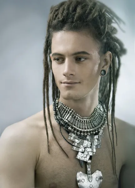 Handsome guy with dreadlocks and jewelry — Stock Photo, Image