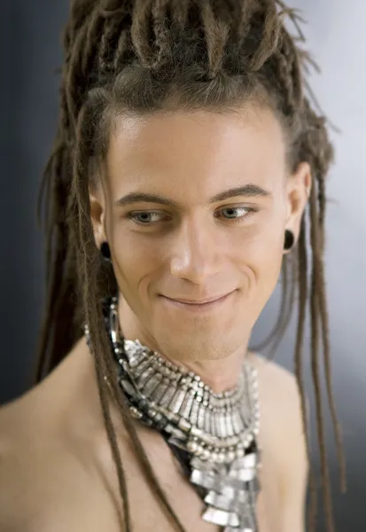 A cute stylish handsome guy with dreadlocks and jewelry — Stock Photo, Image