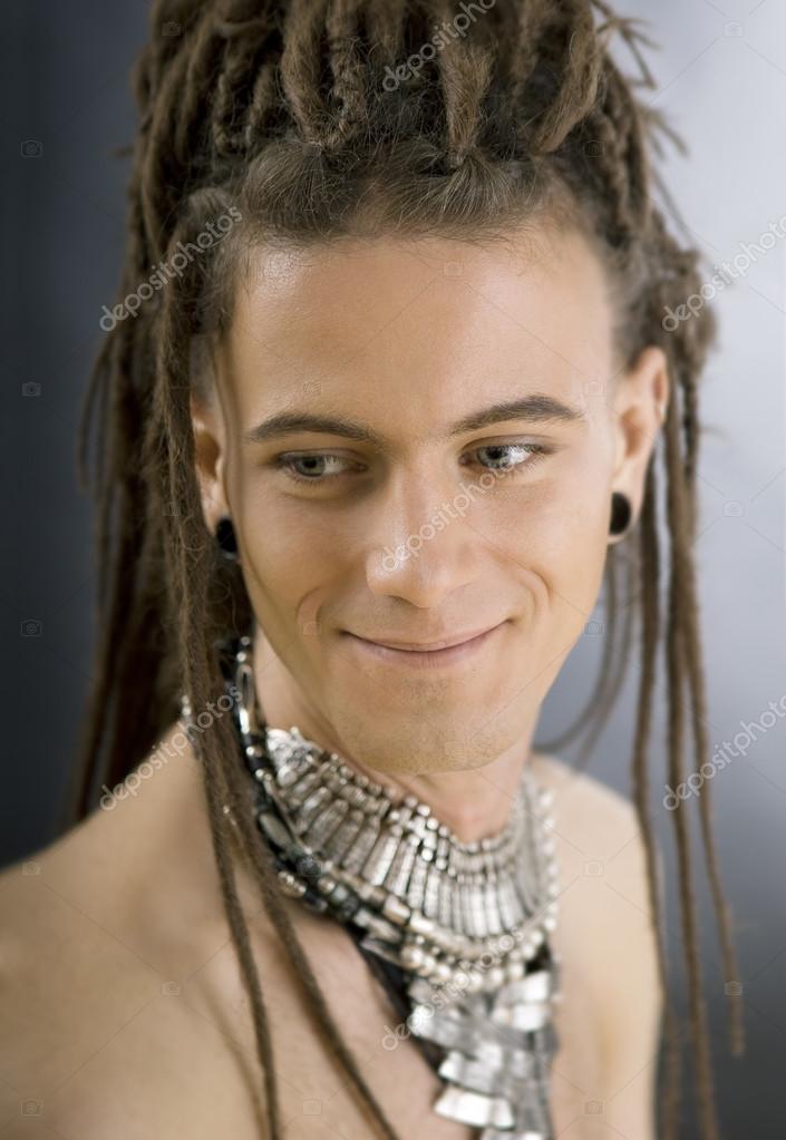 A cute stylish handsome guy with dreadlocks and jewelry — Stock