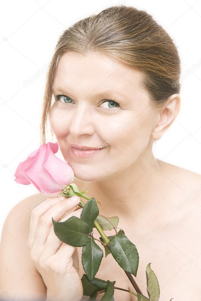 Attractive mid adult woman with a pink rose , female face of bea