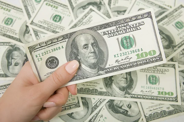 A lot of money (U.S. dollars), hand holding a hundred dollar — Stock Photo, Image