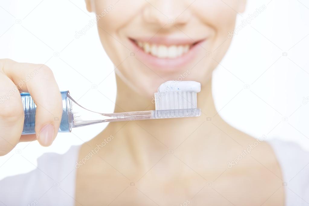Closeup girl with toothbrush cleaning teeth at home, whiten toot