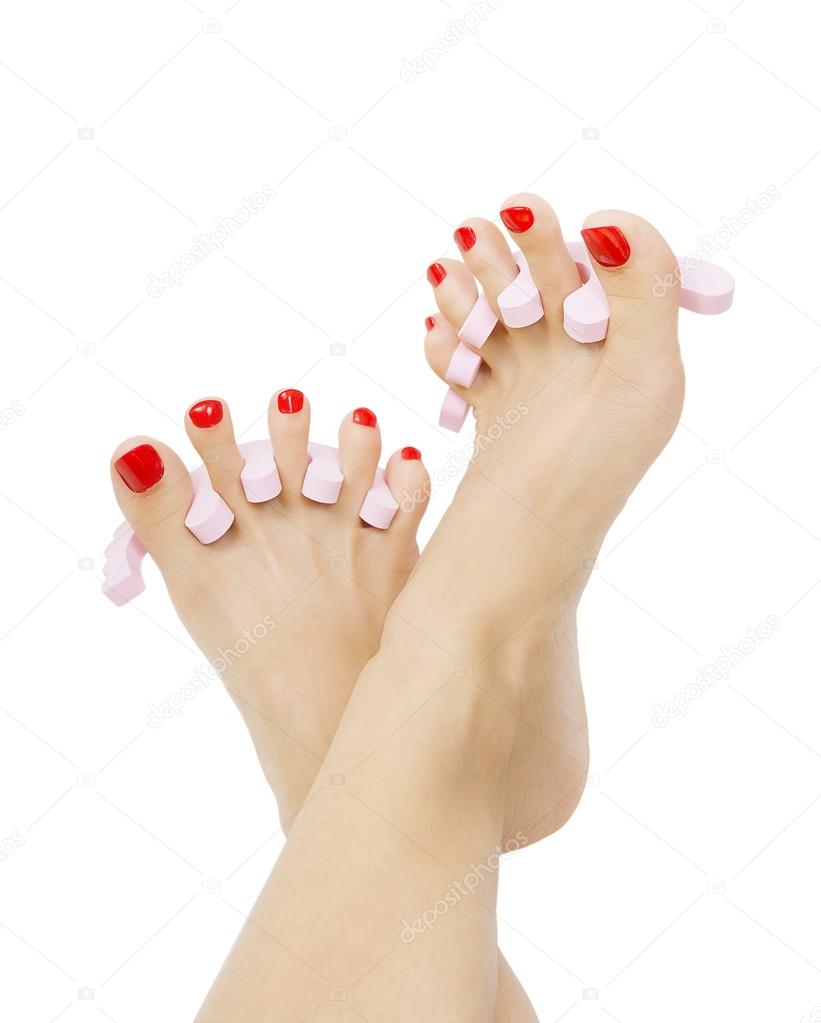 female foot with red pedicure close up, isolated