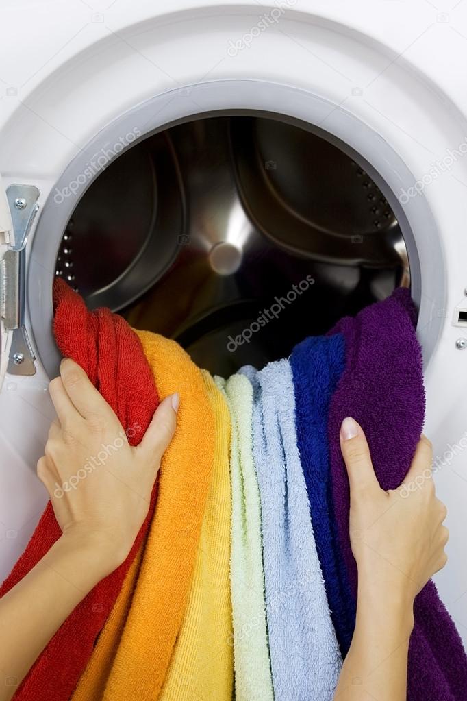 woman taking color clothes from washing machine