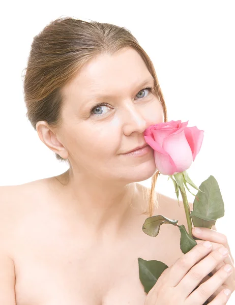 Attractive mid adult woman with a pink rose, female face of beau — Stock Photo, Image