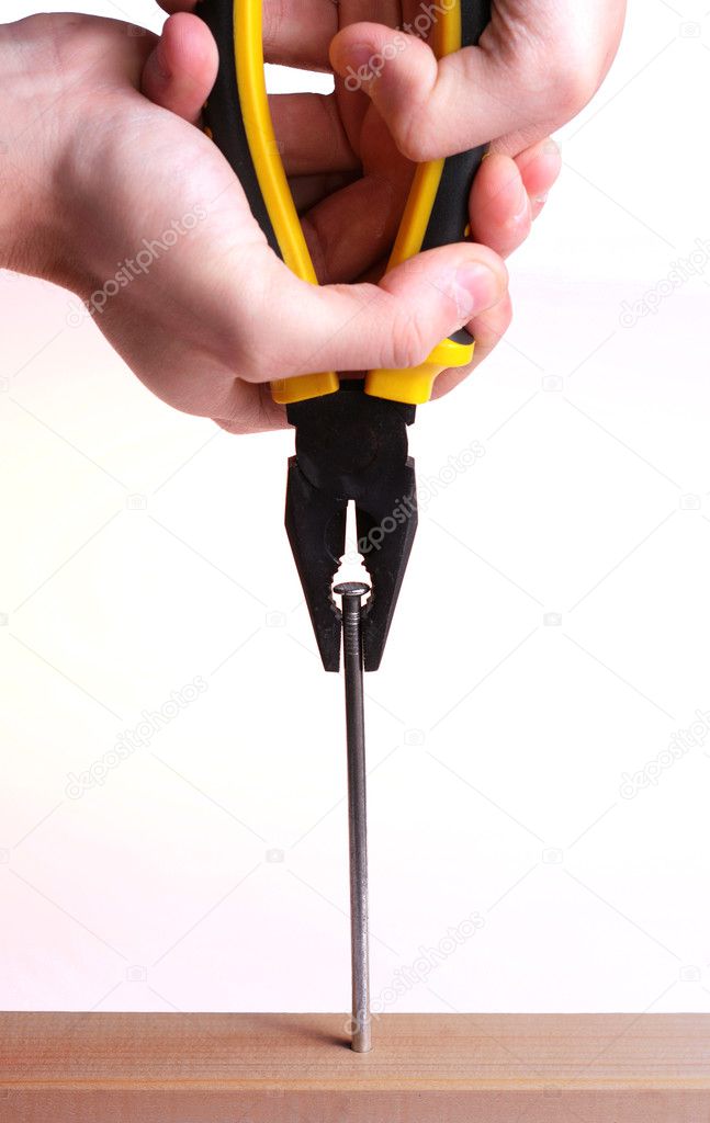 Pulling a nail with pliers