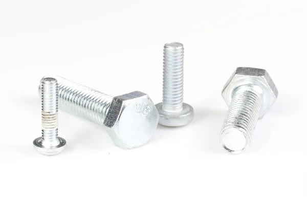 Four silver metal screws isolated on white background. — Stock Photo, Image