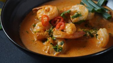 Tayland karidesleri kırmızı köri. Tayland geleneği karides ve hindistan cevizi sütüyle kırmızı köri çorbası. Panaeng Curry ve koyu arkaplan.