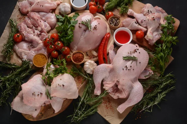 Different types of fresh chicken meat. Whole raw chicken, fillet, thigh, boneless breast, and legs with spices for barbecue grill.