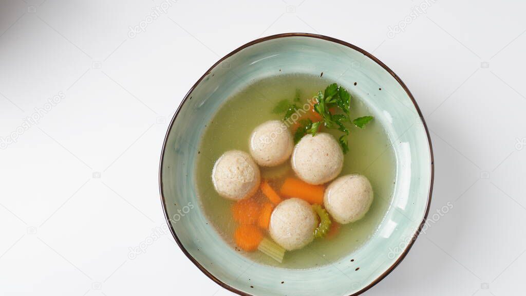 Jewish chicken broth with kneidlach (balls made with matzo meal)Matzo ball soup