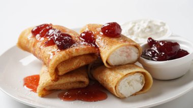 Pancakes with sweet cottage cheese and strawberry jam for breakfast