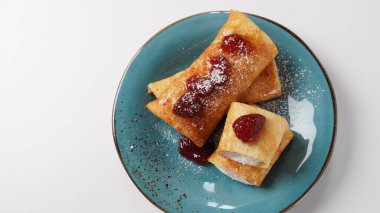 Pancakes with sweet cottage cheese and strawberry jam for breakfast