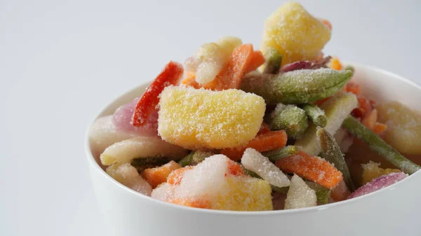 Homemade frozen various vegetables. Frozen vegetable mix on white background